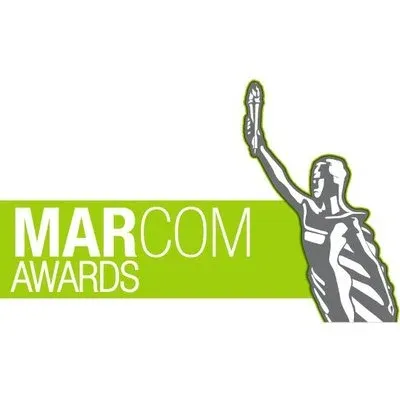 "MARCOM AWARDS" logo with a gray statue raising a torch on a green banner