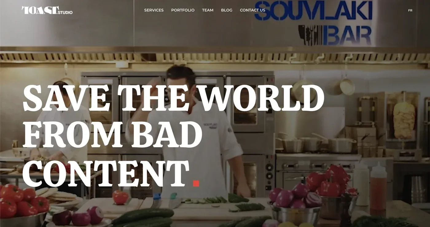Toast Studio homepage reading "Save the World from Bad Content" over a restaurant kitchen with chefs and vegetables.