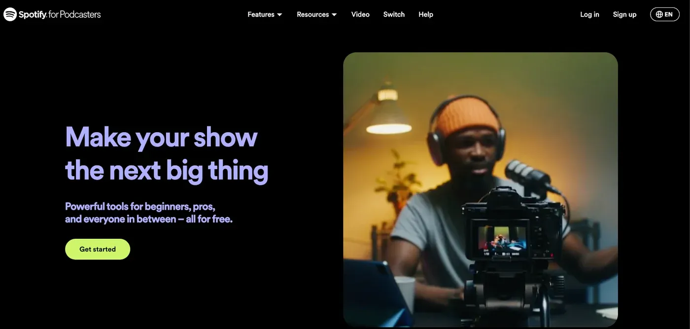 Spotify for Podcasters homepage headline "Make your show the next big thing" beside a person recording at a mic