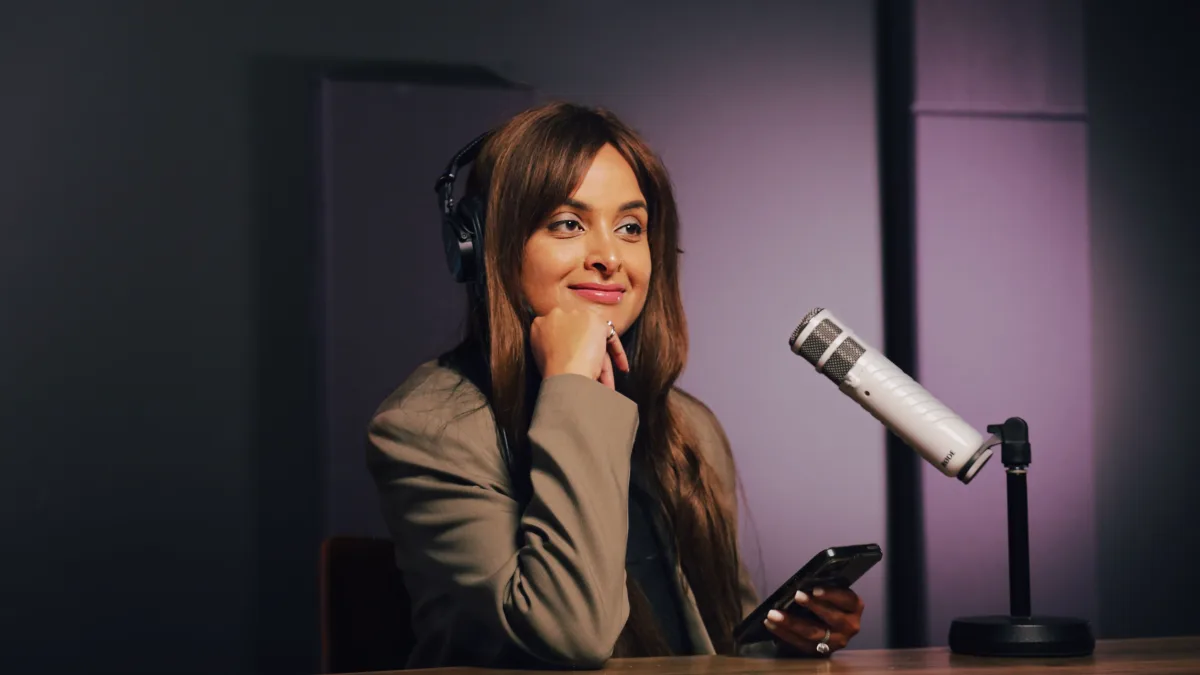 A podcaster recording in a studio